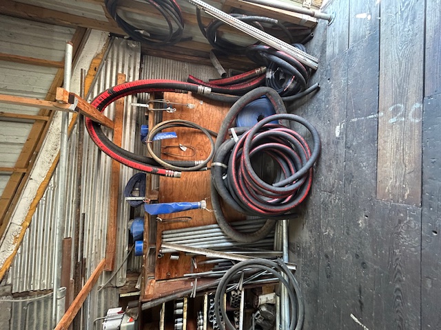 Industrial hoses hanging on display wall
