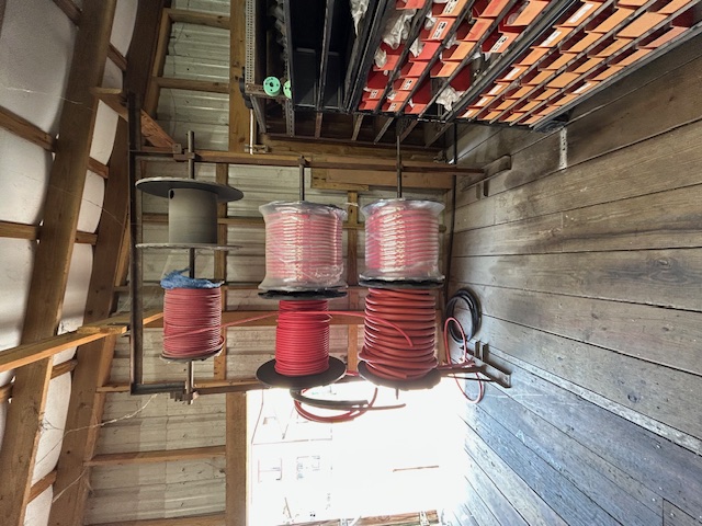 Red air hose reels and spools on display